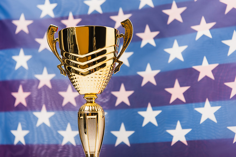 Photo of award superimposed over an american flag